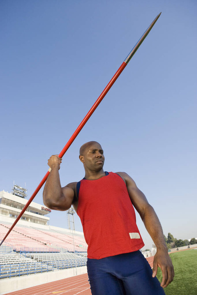 African American male athlete about to throw javelin in stadium - Fotografie, Obrázek