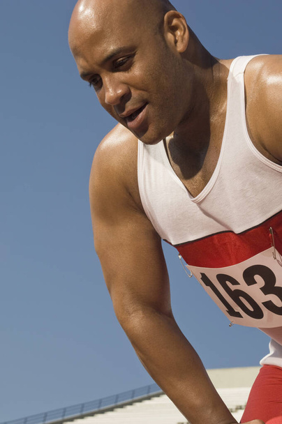 African American male athlete against clear sky - Foto, Bild