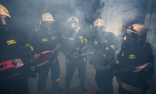 Group of firemen with gas masks standing in the middle of the ch - Photo, Image
