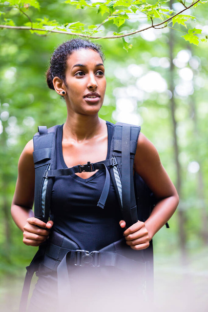 African young woman hiking on forest track - Foto, Imagen