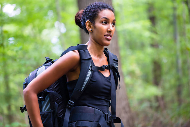 African young woman hiking on forest track - Foto, Imagen