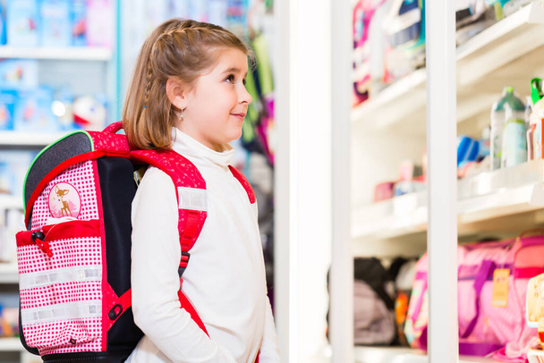 Little girl choosing supplies for first day in school - Photo, image