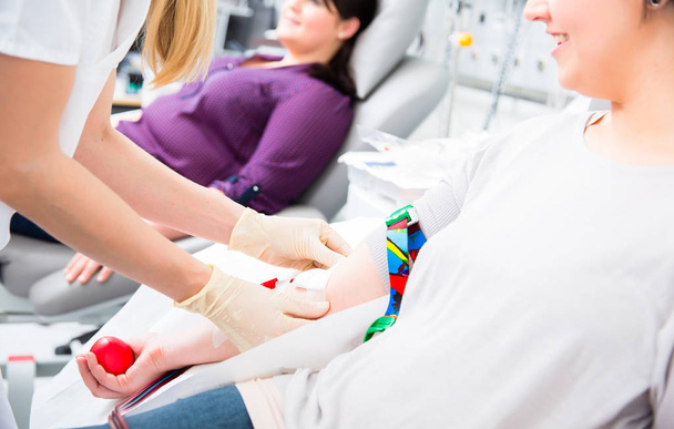 Nurse in drop-in department taking blood from woman donor - Zdjęcie, obraz