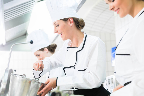 Team of chefs in production process of system catering - Фото, изображение