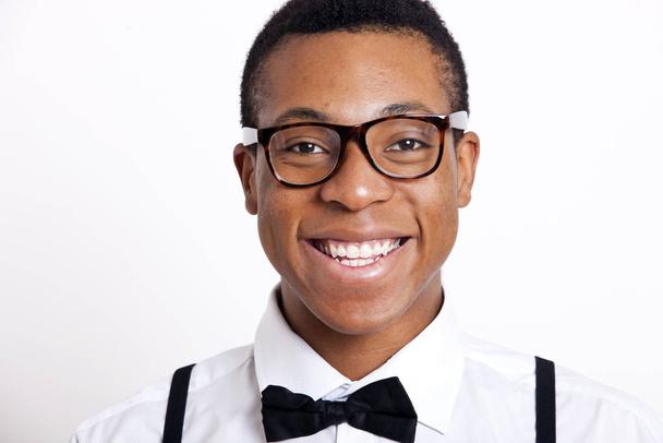 Portrait of young man wearing eyeglasses against white background - Foto, imagen