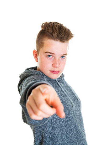 teenager in front of white background pointing in to the camera - Photo, Image