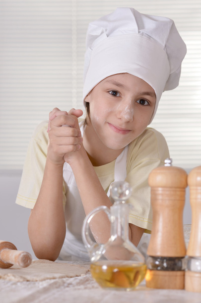 Boy knead the dough - Фото, изображение