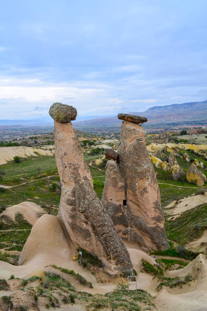 Fairytale landscape with unusual mountain formations. Three Sisters Rocks in Turkish Cappadocia - Fotoğraf, Görsel