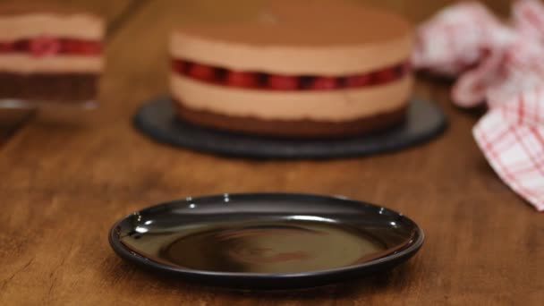 Piece of delicious chocolate mousse cake with raspberries jelly. - Imágenes, Vídeo