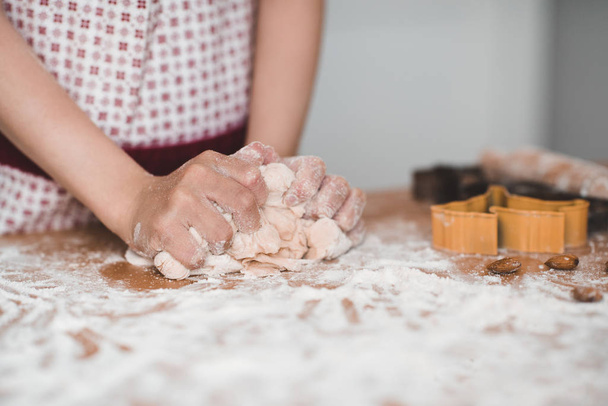 Kid girl kneading dough with flour closeup. Making cookies.  Childhood.  - Photo, Image
