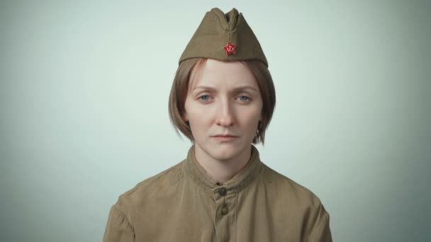 Video of young woman in soviet red army uniform on white - Footage, Video