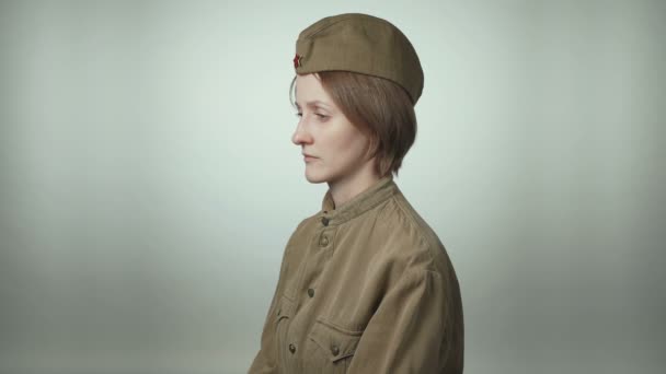 Wideo z młodą kobietą w sowieckim mundurze na białym - Materiał filmowy, wideo