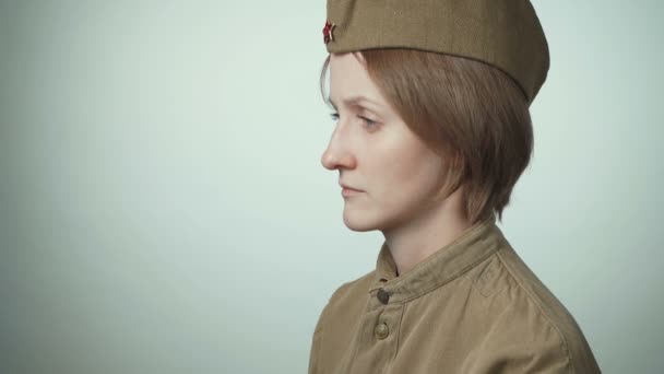 Video of woman wearing soviet army uniform on white - Footage, Video