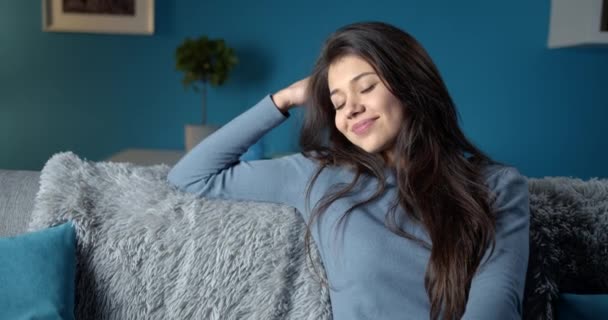 Happy woman with dark hair relaxing at home - Filmmaterial, Video