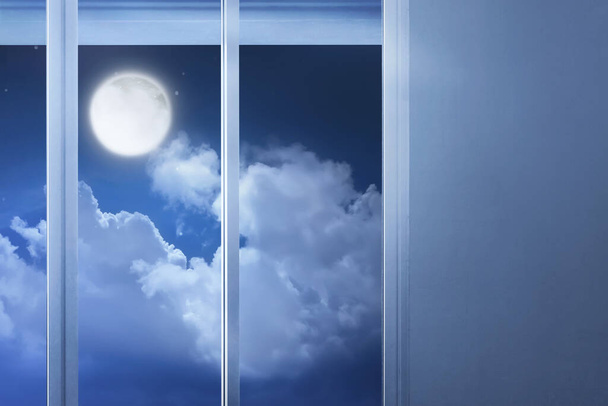Window glass in the empty room with moonlight at night - 写真・画像