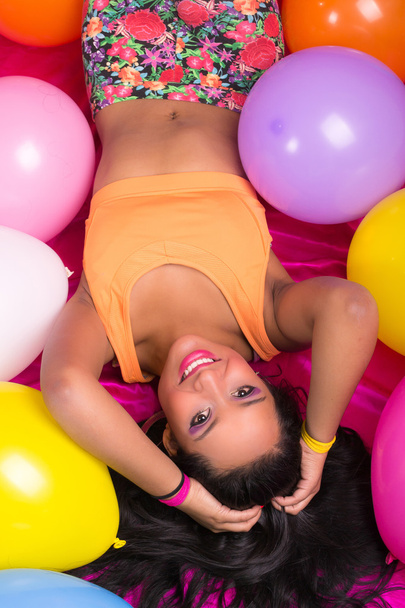 Happy hispanic woman with balloons - 写真・画像