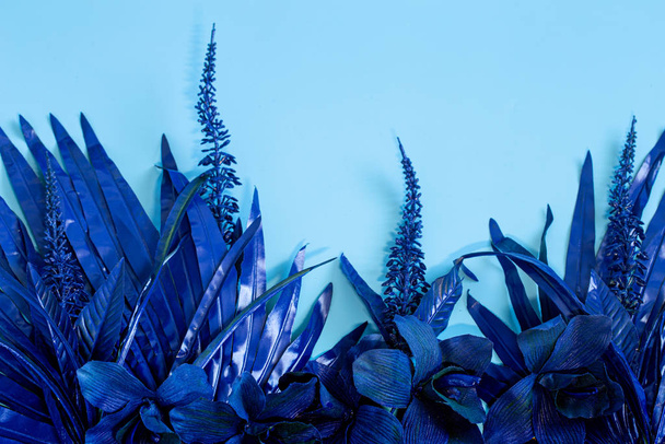 artificial tropical beautiful blue flowers and leaves. - Photo, Image