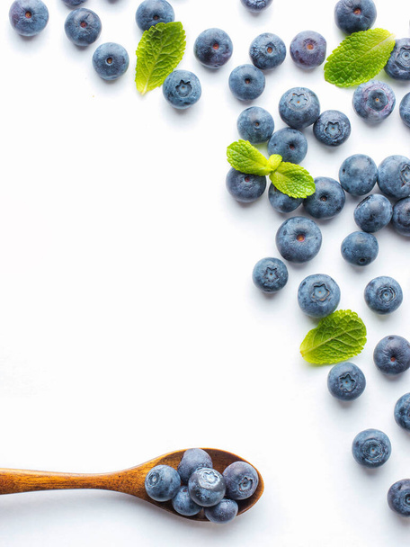 Blueberries isolated on white background. Blueberry border design. Ripe and juicy fresh picked bilberries close up. Copyspace. Top view or flat lay - 写真・画像