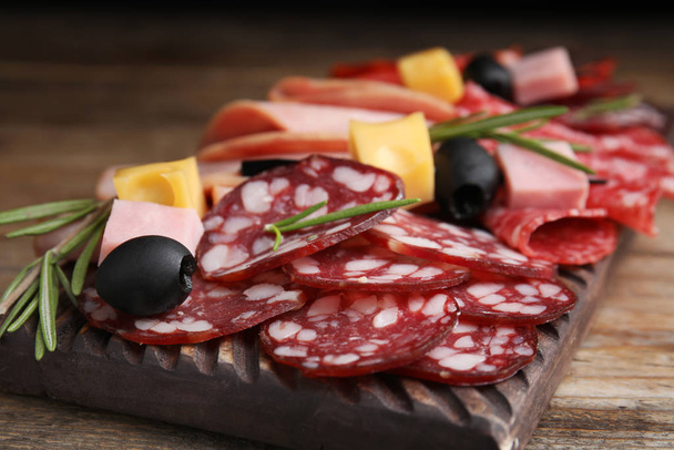 Tasty ham with other delicacies served on wooden table, closeup - Zdjęcie, obraz