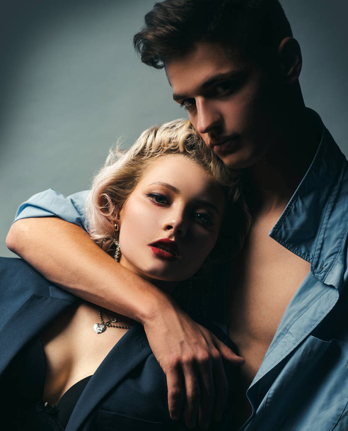 Handsome guy is hugging pretty girl with blonde hair. I Love You. Passion sex. Husband and wife get sexual pleasure from hugging. Muscular man. Pose for family portrait. - Zdjęcie, obraz