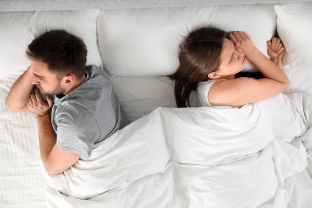 Unhappy couple with relationship problems after quarrel in bed,  - Foto, afbeelding