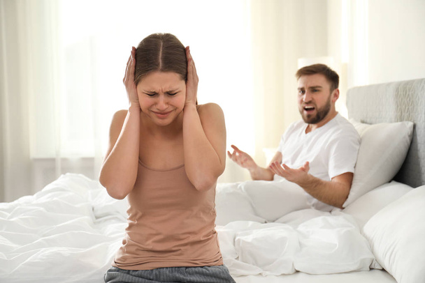 Unhappy young couple quarreling at home. Relationship problems - 写真・画像