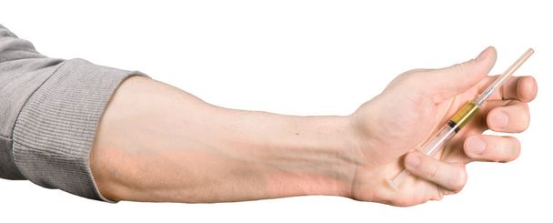 Чоловіча рука тримає шприц з наркотичним ізольованим
 - Фото, зображення