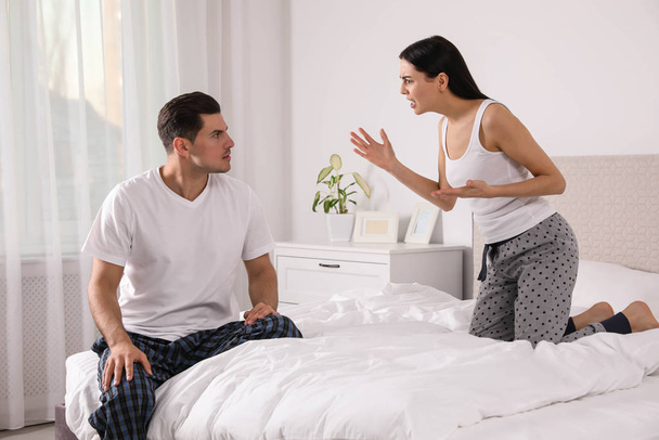 Couple with relationship problems quarreling in bedroom - Fotó, kép