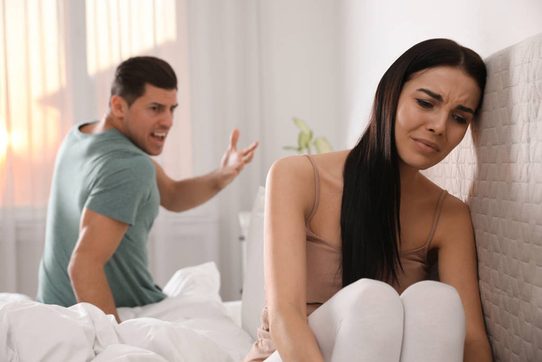 Couple with relationship problems quarreling in bedroom - Φωτογραφία, εικόνα