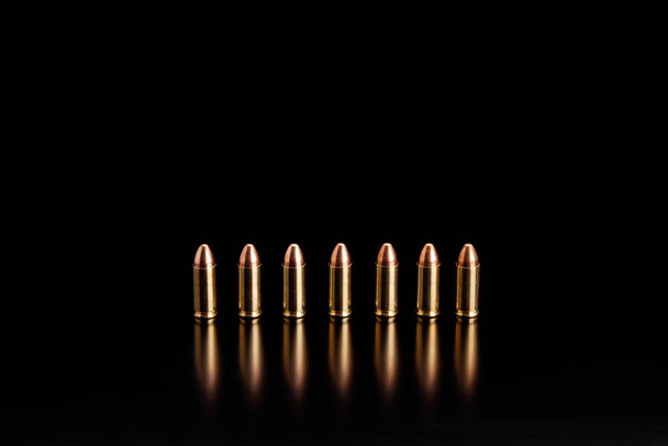 Bullet isolated on black background with reflexion. Rifle bullet - Foto, immagini