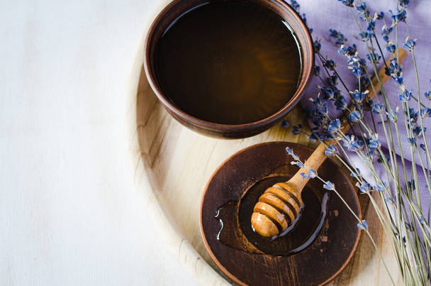 Organic honey and lavender flowers on wooden table. Rustic stile. - Fotó, kép