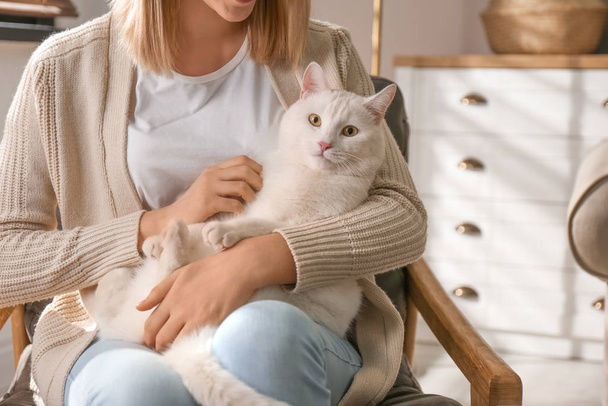 Young woman with her beautiful white cat at home, closeup. Fluff - Fotografie, Obrázek