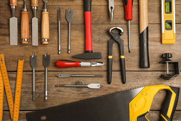 Flat lay composition with carpenter's tools on wooden background - 写真・画像
