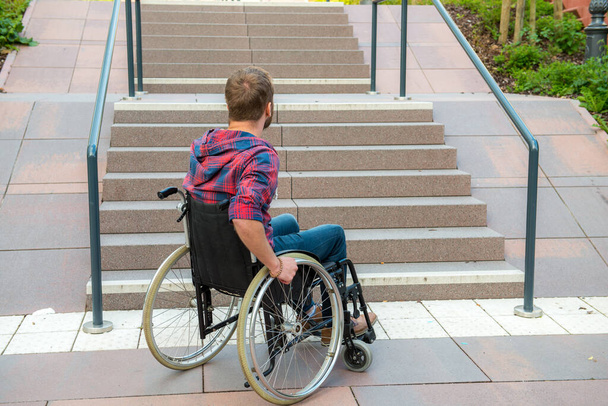young disabled man in wheelchair in front of stairs - Foto, Imagem