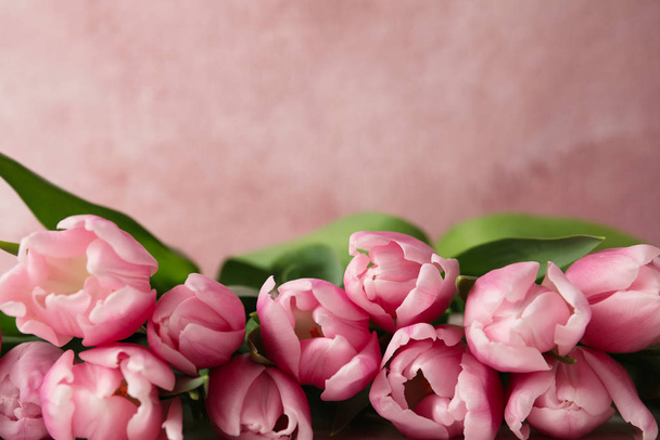 Beautiful spring tulips on light pink background, closeup. Space - Foto, imagen