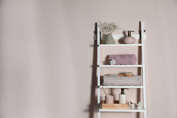 Shelving unit with toiletries near light wall indoors, space for - Zdjęcie, obraz