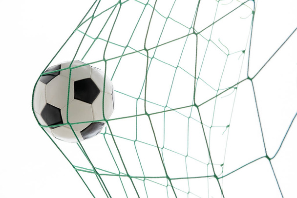 soccer ball in green goal in front of white background - Foto, imagen