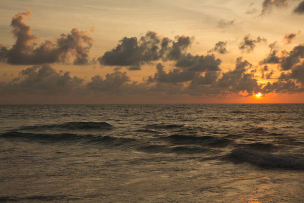 a beautiful sunset in the sea on the beach - Photo, Image