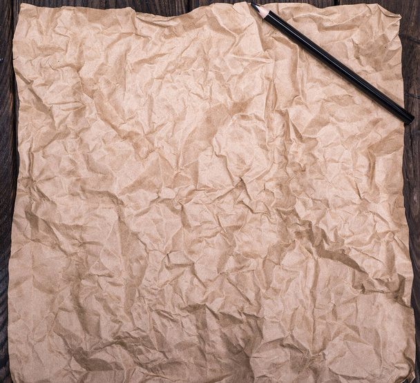 brown kraft paper and black wooden pencil, empty space - Foto, Bild
