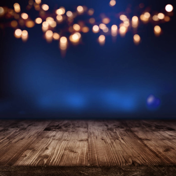 blue illuminated backdrop with golden bokeh for a festive decoration - Foto, imagen