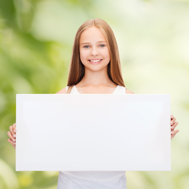 Little girl with blank white board - Фото, изображение