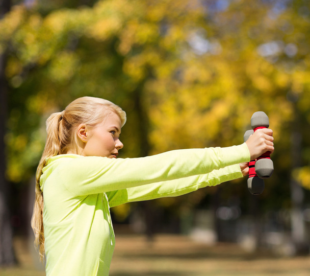 Sporty woman with light dumbbells outdoors - Φωτογραφία, εικόνα