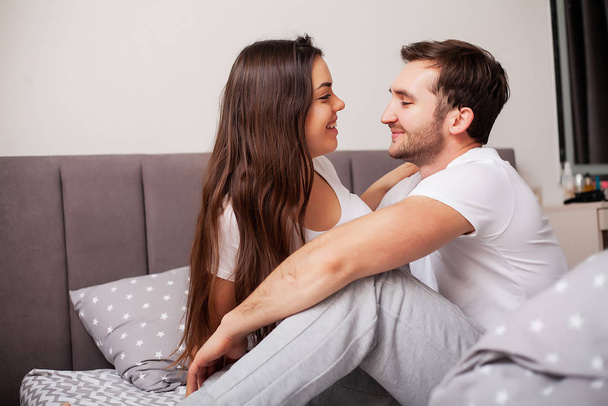 Intimate sensual young couple in bedroom enjoying each other - Фото, изображение