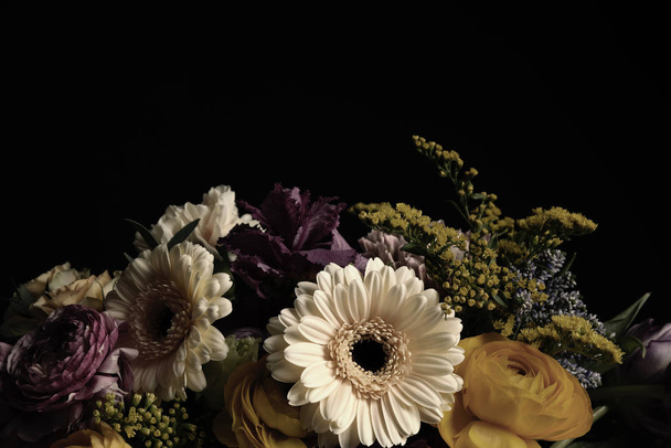 Beautiful bouquet of different flowers on black background. Floral card design with dark vintage effect - Photo, Image