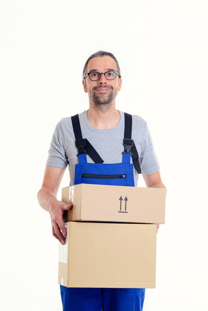 friendly postman with parcels in front of white background - Foto, Bild