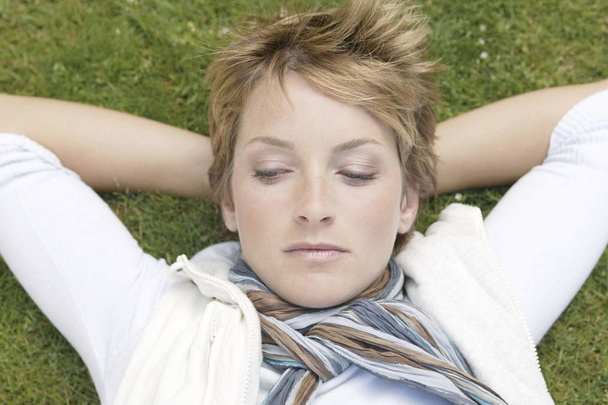 young woman lying on the grass - Foto, Imagen