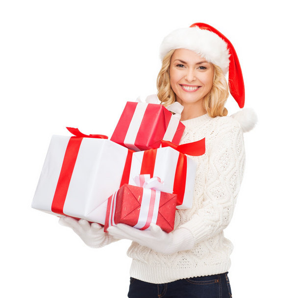Woman in santa helper hat with many gift boxes - Photo, Image