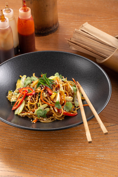 Stir fry with soba noodles, vegetables. Asian healthy food, stir fried meal in bowls. Spicy noodles. Vegetarian Noodles or Vegetable Hakka Noodles or Chow Mein. Indo-chinese cuisine hot dish - Photo, Image