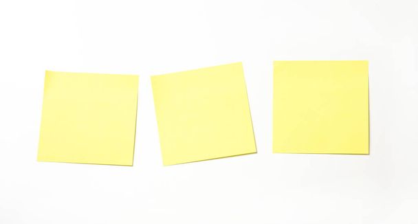 Yellow sticky note isolated on white background. - Foto, afbeelding