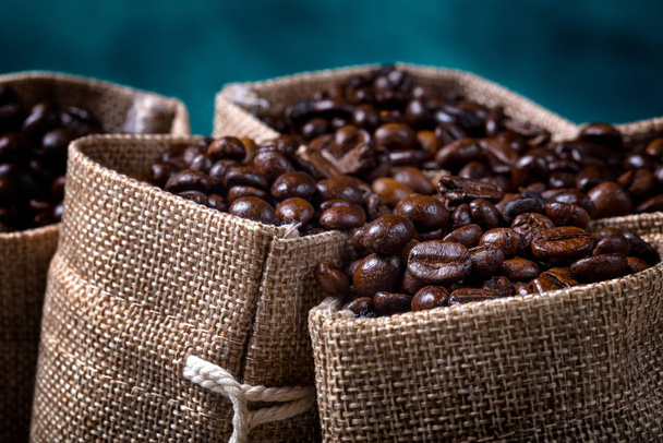 Jute bags filled with coffee beans - Фото, зображення